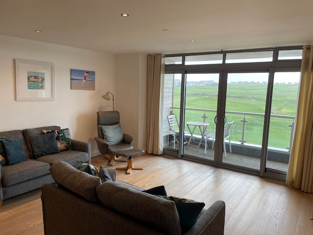 luxurious lounge with stunning views of Newquay golf course and the surf on Fistral Beach, Cornwall