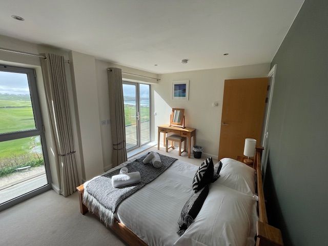 Double bedroom with seaviews across Newquay golf course and the Fistral Beach surf with access to balcony