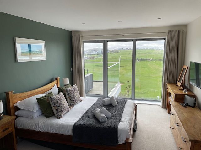 Main bedroom with sea views across Newquay golf course and the Fistral Beach surf with access to balcony