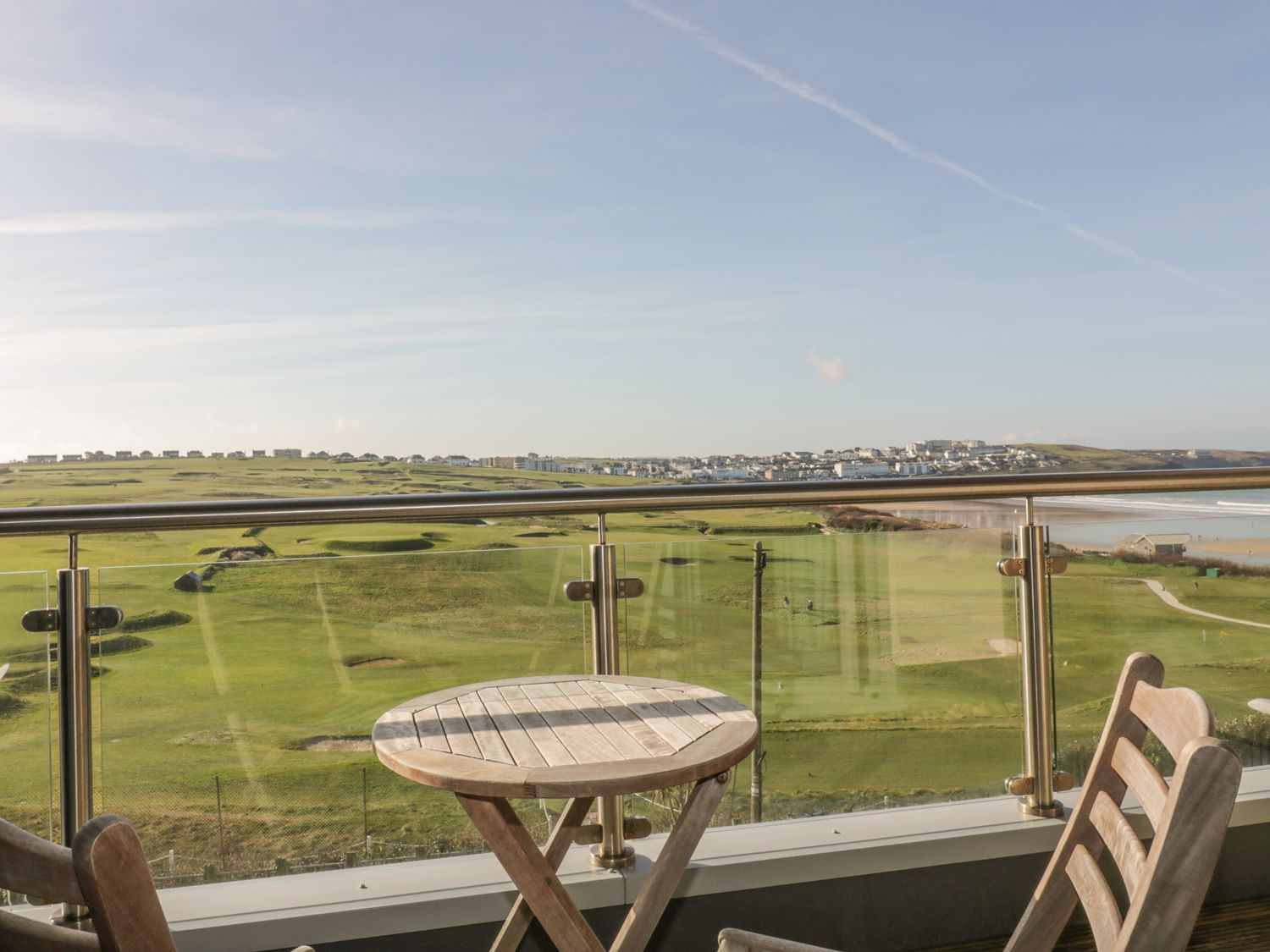 The balcony is the perfect place to relax with stunning views of Newquay golf course and the surf on Fistral Beach