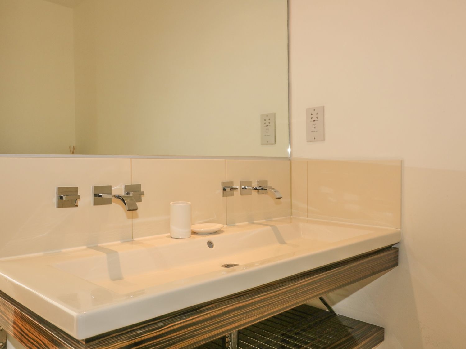 Double basin perfect for families in the stylish bathroom with shower