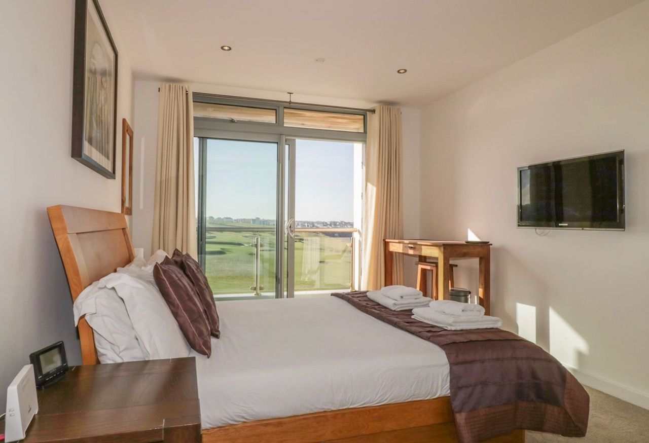 Main bedroom with ensuite and  sea views across Newquay golf course and the Fistral Beach surf.